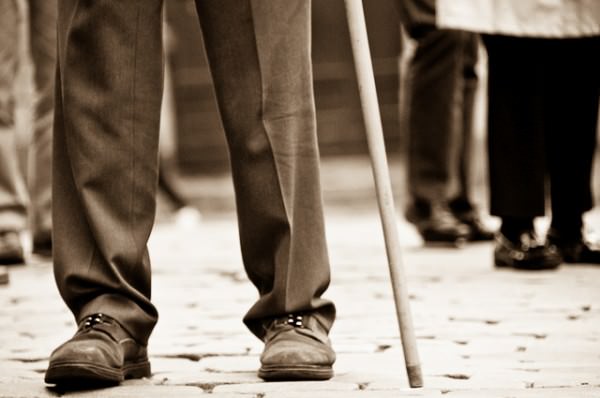 Limping by on Walking Cane Limping by on Walking Cane