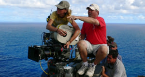 Camera Operator and AC on Dolly Above Water